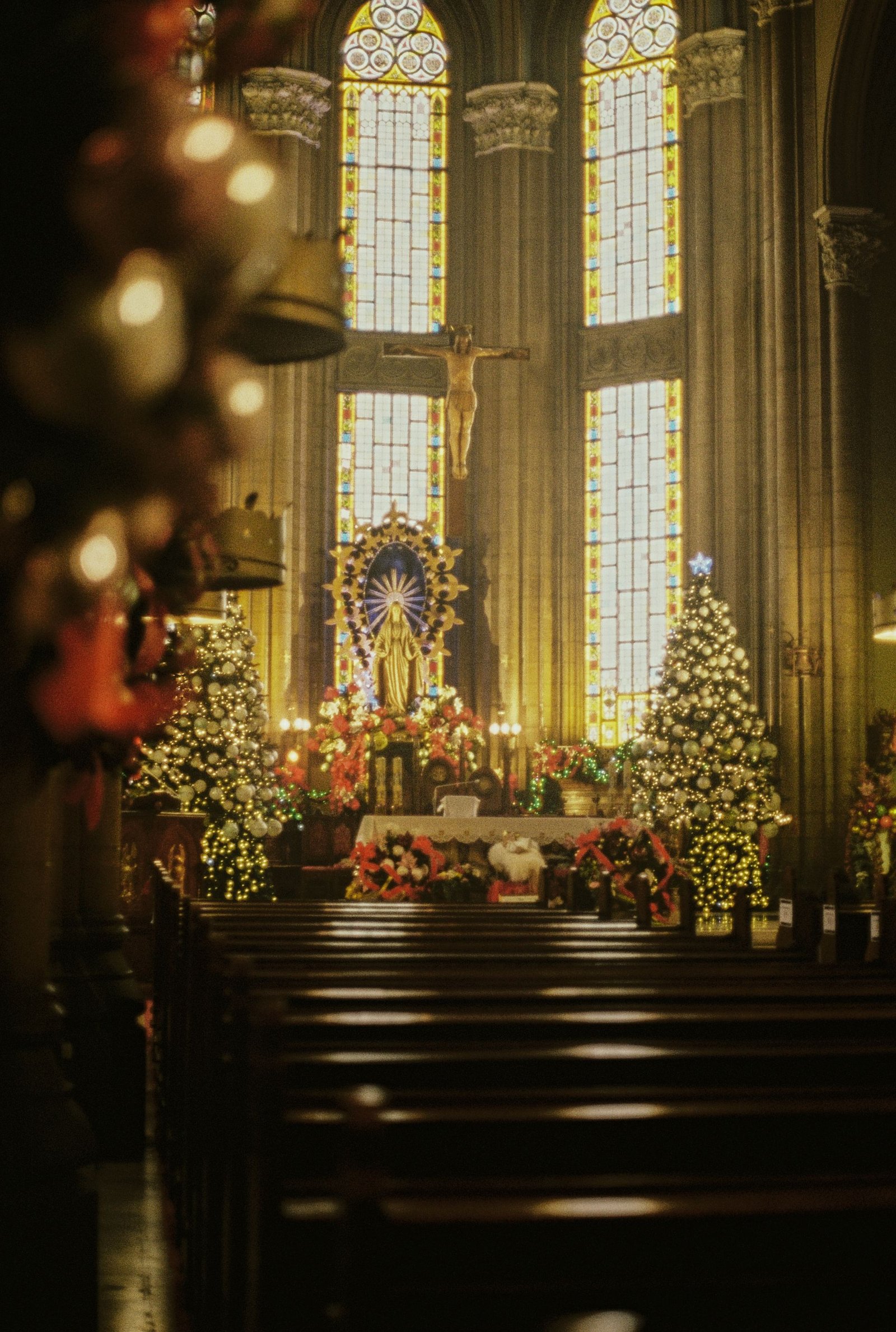 An ornate church sanctuary with stained glass and an altar